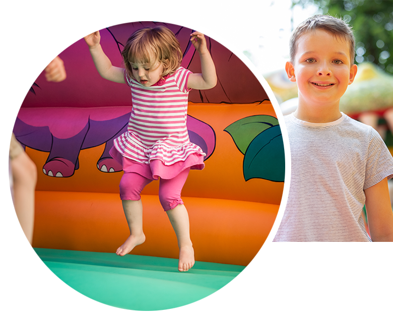 Bouncy castle rentals. Two kids joyfully bouncing on an inflatable castle, surrounded by colorful balls and a safety net.