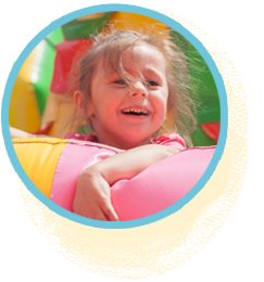Bouncy castle rentals. A joyful child with a beaming smile, happily bouncing in a vibrant inflatable castle.